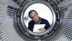 Man looking into a machine Man looking into a machine