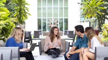 INSEAD participants, could be Master in Management, chatting about MIM curriculum in one of the outdoor seating areas